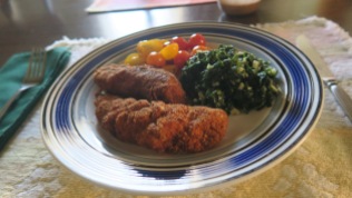Chicken tenders done like cutlets with spinach and garlic and cherry tomatoes from the garden.